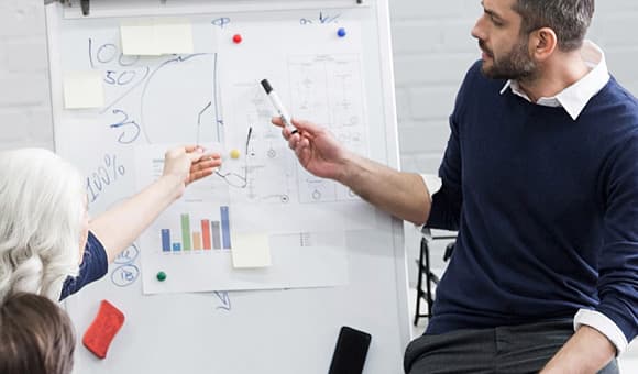 business people using a whiteboard